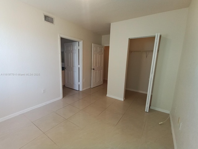 503 Belmont Ln Unit 503, North Lauderdale, FL 33068 - unfurnished bedroom featuring a closet, a spacious closet, and light tile patterned floors