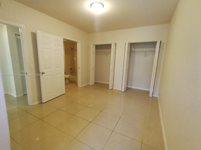 503 Belmont Ln Unit 503, North Lauderdale, FL 33068 - unfurnished bedroom with multiple closets and light tile patterned floors