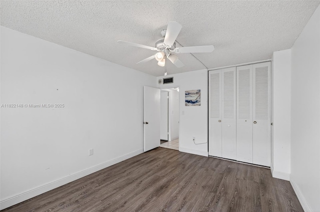 2851 NE 183rd St Unit 216E, Aventura, FL 33160 - unfurnished bedroom with wood finished floors, a closet, a textured ceiling, and a ceiling fan