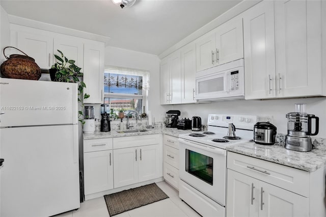 7502 NW 30th Pl Unit 112, Sunrise, FL 33313 - kitchen featuring white appliances, white cabinets, light tile patterned floors, and light stone counters