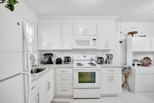 7502 NW 30th Pl Unit 112, Sunrise, FL 33313 - kitchen with white appliances, white cabinets, and light stone countertops
