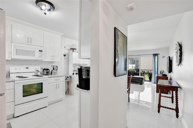7502 NW 30th Pl Unit 112, Sunrise, FL 33313 - kitchen featuring white appliances, light tile patterned floors, and white cabinets