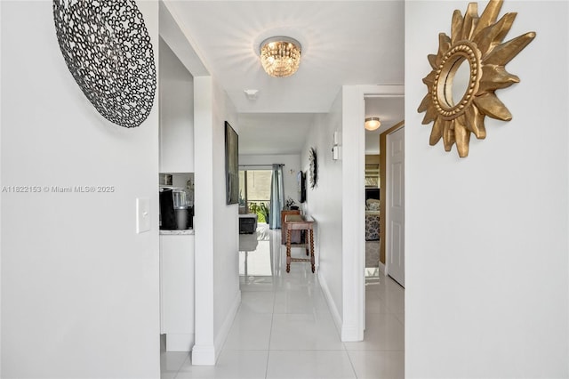 7502 NW 30th Pl Unit 112, Sunrise, FL 33313 - corridor with light tile patterned flooring and a chandelier