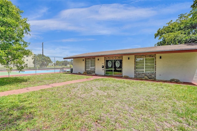 7502 NW 30th Pl Unit 112, Sunrise, FL 33313 - ranch-style home with stucco siding and a tennis court