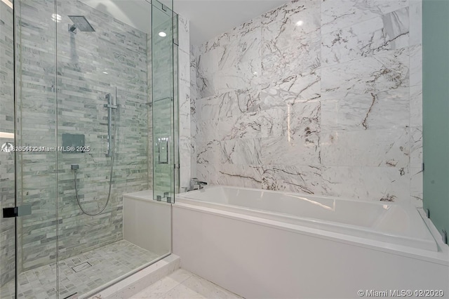 851 NE 1st Ave Unit 1608, Miami, FL 33132 - full bath featuring a bath, a shower stall, and tile walls