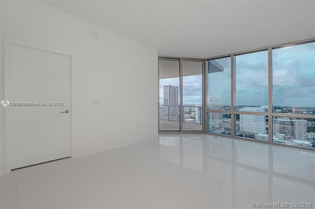 851 NE 1st Ave Unit 1608, Miami, FL 33132 - tiled spare room with a city view and expansive windows