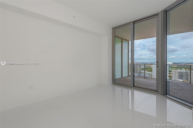 851 NE 1st Ave Unit 1608, Miami, FL 33132 - tiled empty room featuring expansive windows