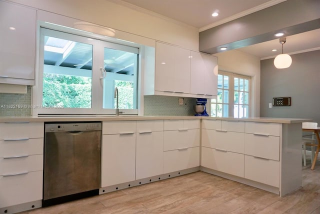 13200 SW 59th Ave, Pinecrest, FL 33156 - kitchen with stainless steel dishwasher, ornamental molding, decorative backsplash, light wood-style flooring, and light countertops