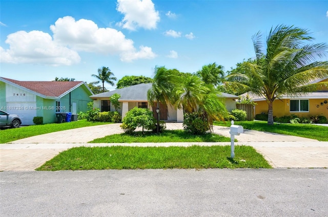 7420 SW 14th Pl, North Lauderdale, FL 33068 - view of front of house with curved driveway, a front yard, and stucco siding