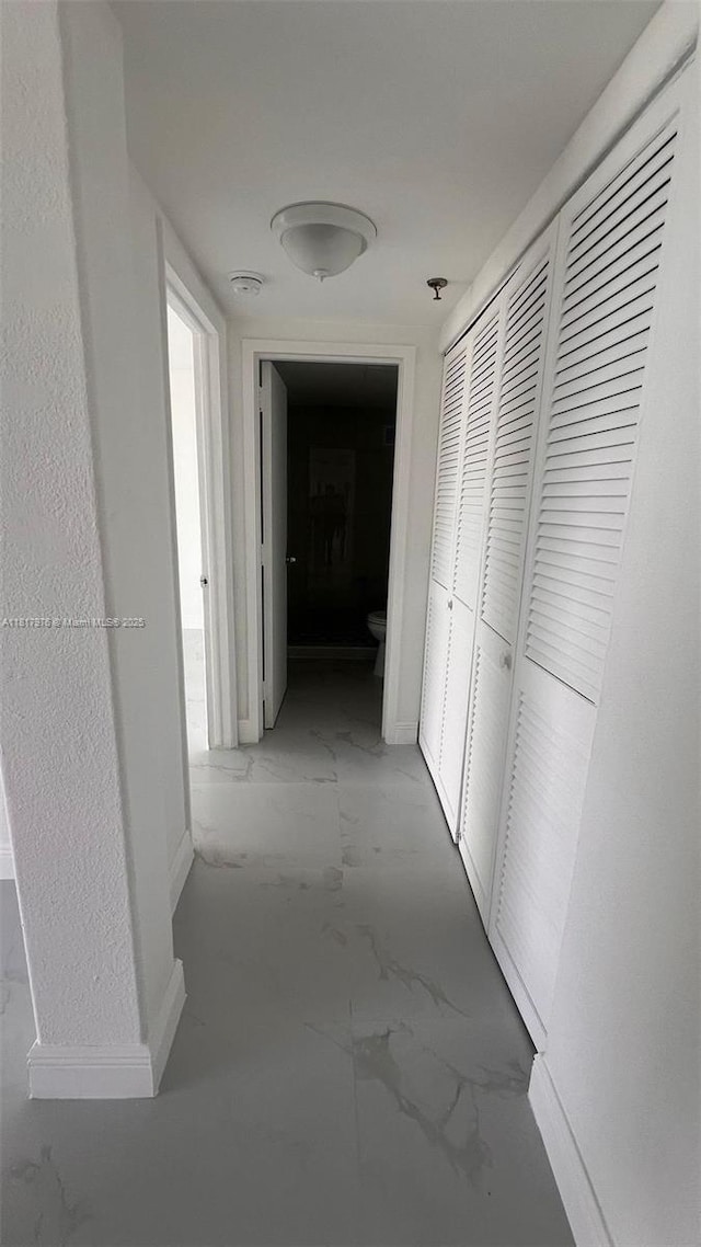 16450 NW 2nd Ave Unit 409, Miami, FL 33169 - hall featuring light marble finish floors and baseboards
