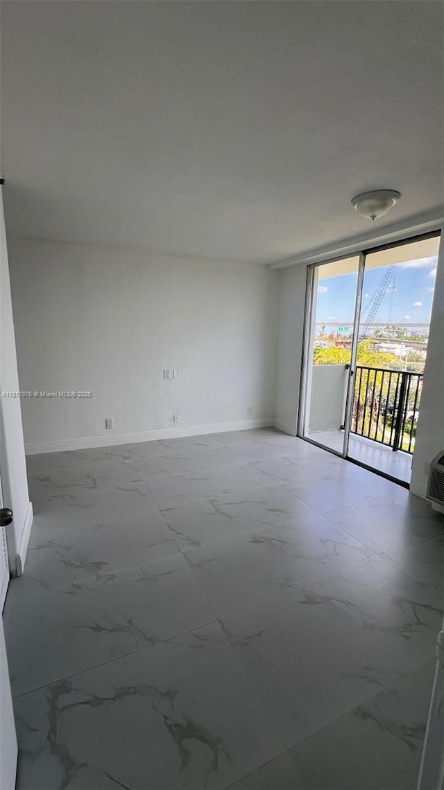 16450 NW 2nd Ave Unit 409, Miami, FL 33169 - spare room featuring expansive windows and marble look tile flooring