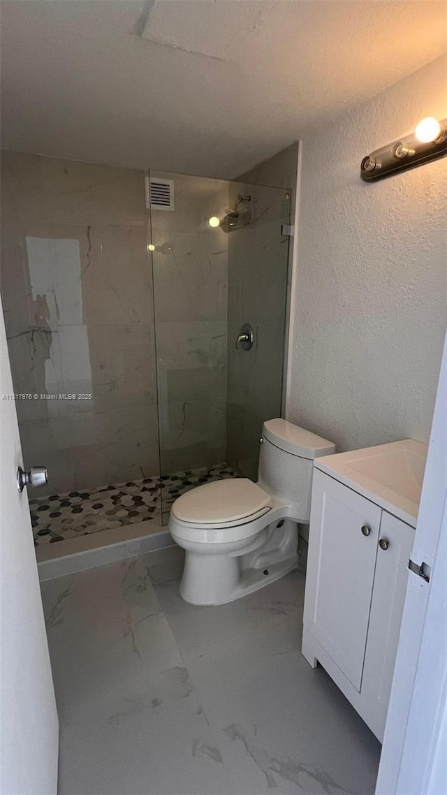 16450 NW 2nd Ave Unit 409, Miami, FL 33169 - full bathroom with vanity, a stall shower, a textured wall, and marble finish floors