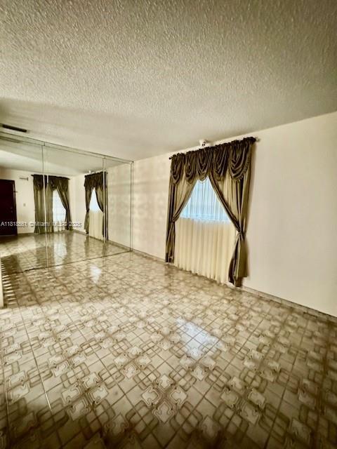 2671 SW 107th Ave, Miami, FL 33165 - unfurnished room featuring a textured ceiling