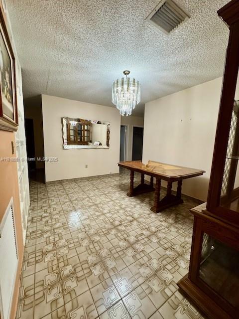 2671 SW 107th Ave, Miami, FL 33165 - playroom with a textured ceiling and a chandelier