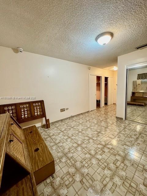 2671 SW 107th Ave, Miami, FL 33165 - unfurnished room with a textured ceiling and a smoke detector