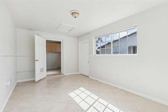 1700 SW 5th Ave, Pompano Beach, FL 33060 - unfurnished bedroom featuring attic access and light tile patterned floors
