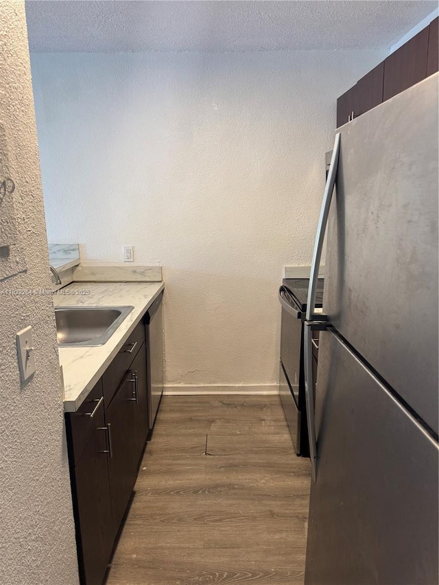 1225 NE 124th St Unit 46A, North Miami, FL 33161 - kitchen with appliances with stainless steel finishes, dark wood finished floors, and dark brown cabinetry