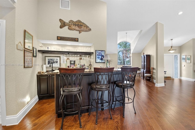10755 Stonebridge Blvd, Boca Raton, FL 33498 - indoor wet bar with dark wood-style flooring and vaulted ceiling