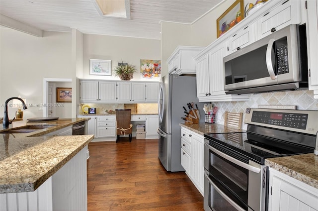 10755 Stonebridge Blvd, Boca Raton, FL 33498 - kitchen featuring appliances with stainless steel finishes, backsplash, white cabinetry, dark wood-type flooring, and light stone countertops