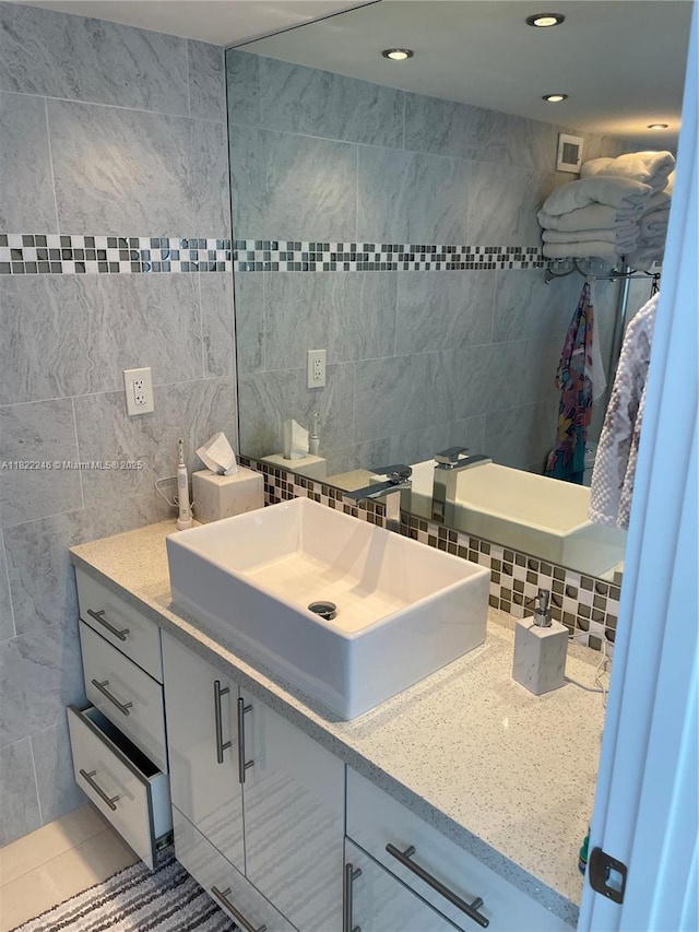 6039 Collins Ave Unit 1525, Miami Beach, FL 33140 - bathroom with tile walls, vanity, tasteful backsplash, recessed lighting, and tile patterned flooring