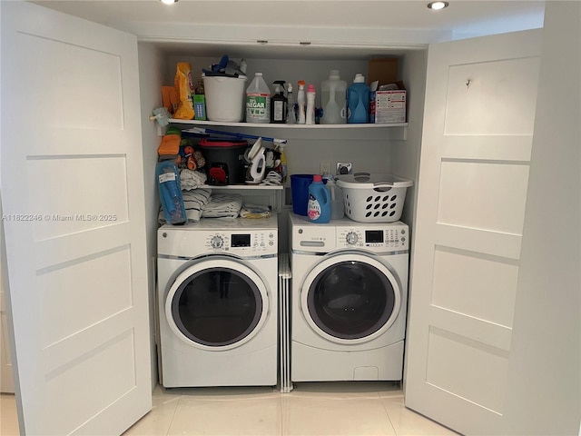 6039 Collins Ave Unit 1525, Miami Beach, FL 33140 - laundry area with washer and dryer, light tile patterned floors, and recessed lighting