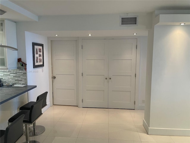 6039 Collins Ave Unit 1525, Miami Beach, FL 33140 - interior space featuring tasteful backsplash, light tile patterned flooring, recessed lighting, and dark countertops