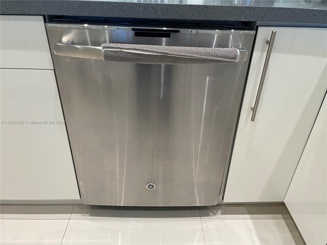 6039 Collins Ave Unit 1525, Miami Beach, FL 33140 - kitchen view of stainless steel dishwasher and white cabinetry