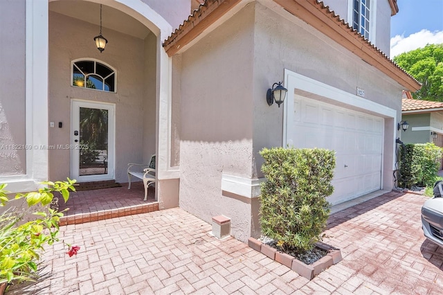 19257 NW 14th St, Pembroke Pines, FL 33029 - doorway to property featuring a tile roof, stucco siding, and a garage