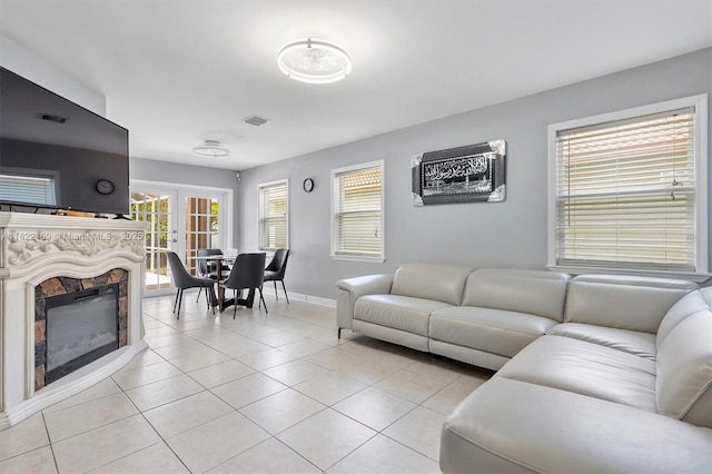 19257 NW 14th St, Pembroke Pines, FL 33029 - living area featuring light tile patterned floors, a glass covered fireplace, and french doors