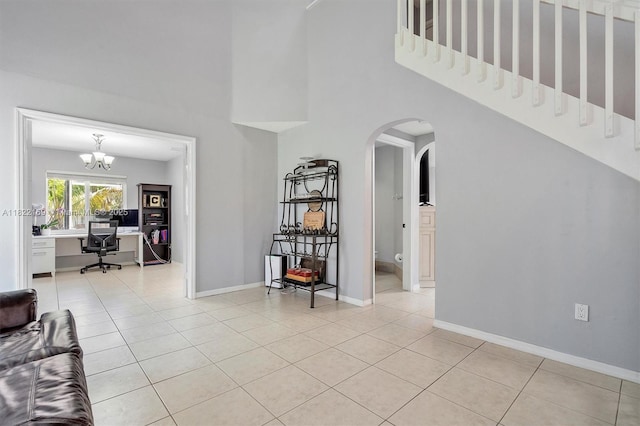 19257 NW 14th St, Pembroke Pines, FL 33029 - living area featuring a desk, arched walkways, a high ceiling, light tile patterned floors, and a chandelier