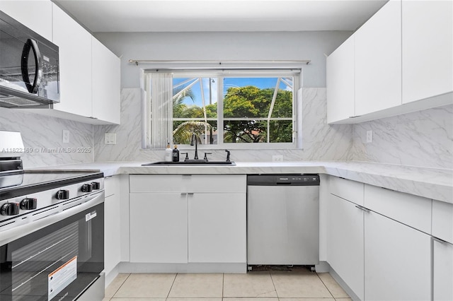 19257 NW 14th St, Pembroke Pines, FL 33029 - kitchen with appliances with stainless steel finishes, white cabinets, and tasteful backsplash