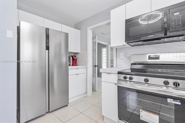 19257 NW 14th St, Pembroke Pines, FL 33029 - kitchen with appliances with stainless steel finishes, light countertops, white cabinetry, and backsplash