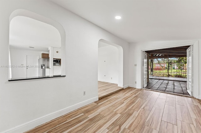 6073 NW 27th St, Margate, FL 33063 - unfurnished room featuring arched walkways, light wood-type flooring, and recessed lighting