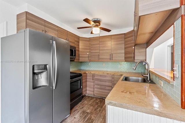 6073 NW 27th St, Margate, FL 33063 - kitchen featuring appliances with stainless steel finishes, a ceiling fan, tasteful backsplash, and light countertops