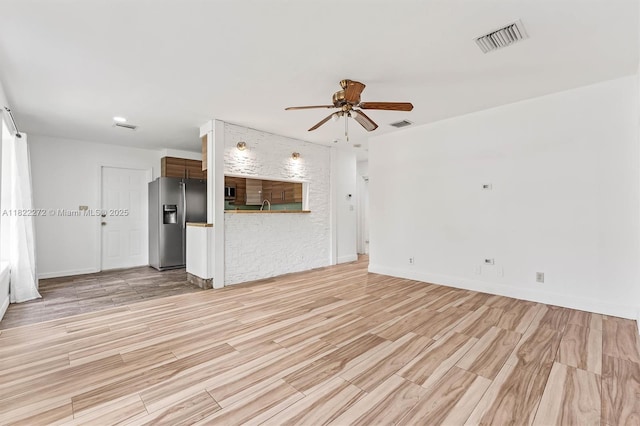 6073 NW 27th St, Margate, FL 33063 - unfurnished living room featuring a ceiling fan and light wood-style flooring