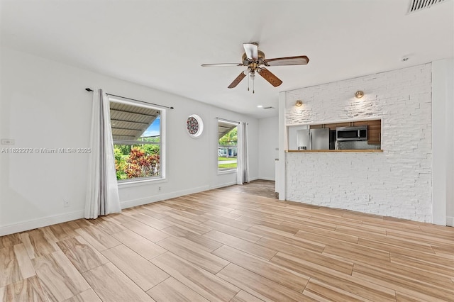 6073 NW 27th St, Margate, FL 33063 - unfurnished living room featuring a ceiling fan, wood finished floors, and a fireplace