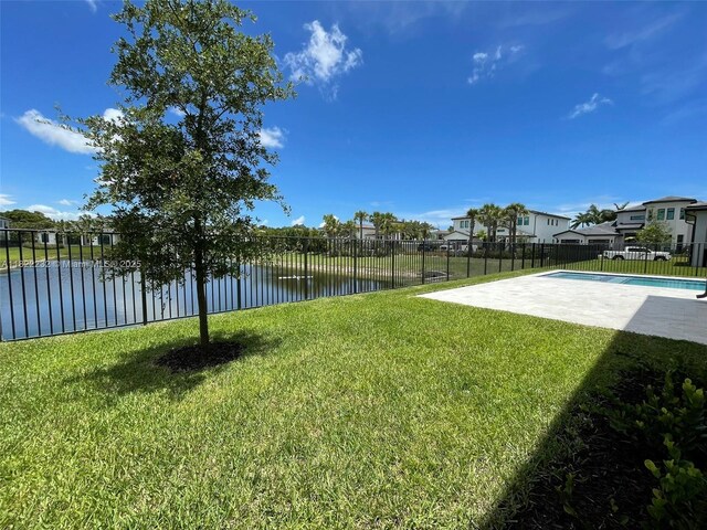 3511 Ashwood Cir S, Hollywood, FL 33312 - fenced backyard with a patio, a water view, and a residential view