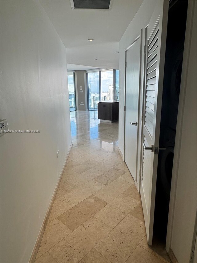 88 SW 7th St Unit 3012, Miami, FL 33130 - corridor featuring baseboards and stone tile floors