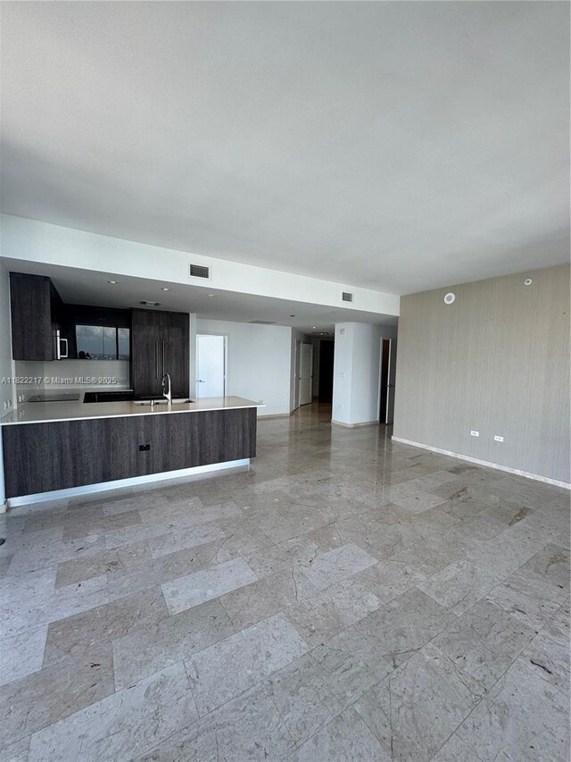 88 SW 7th St Unit 3012, Miami, FL 33130 - unfurnished living room with baseboards and a sink