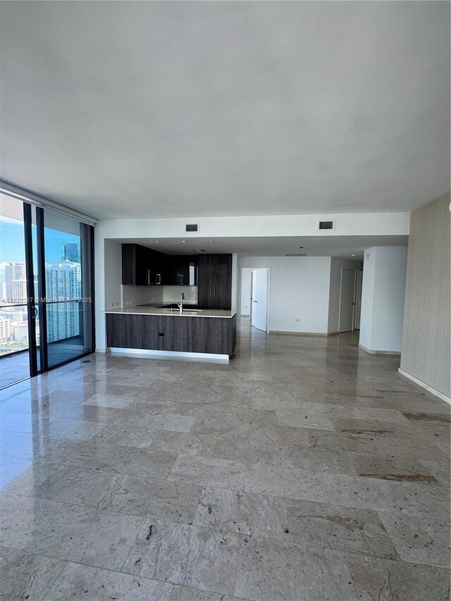 88 SW 7th St Unit 3012, Miami, FL 33130 - unfurnished living room with a sink and a wall of windows