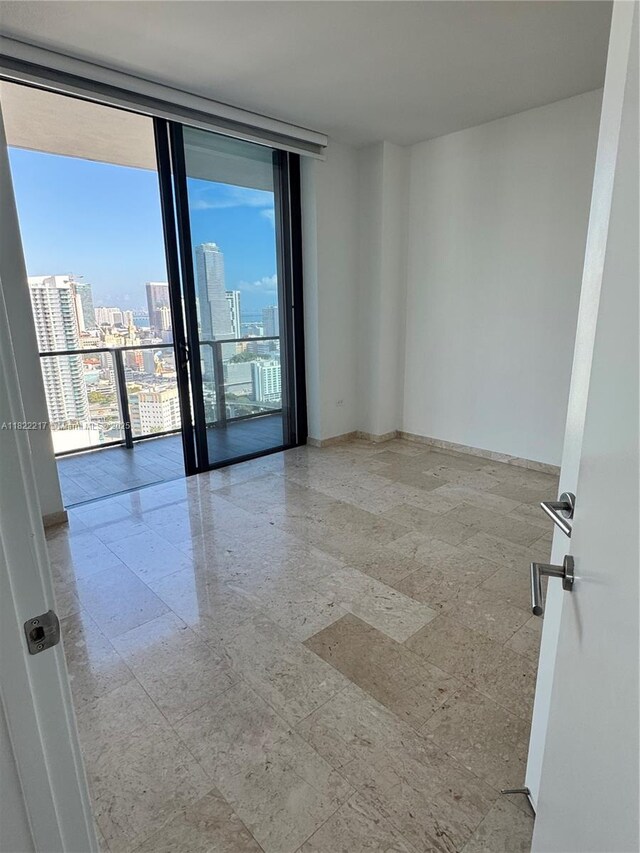88 SW 7th St Unit 3012, Miami, FL 33130 - spare room featuring expansive windows and a city view