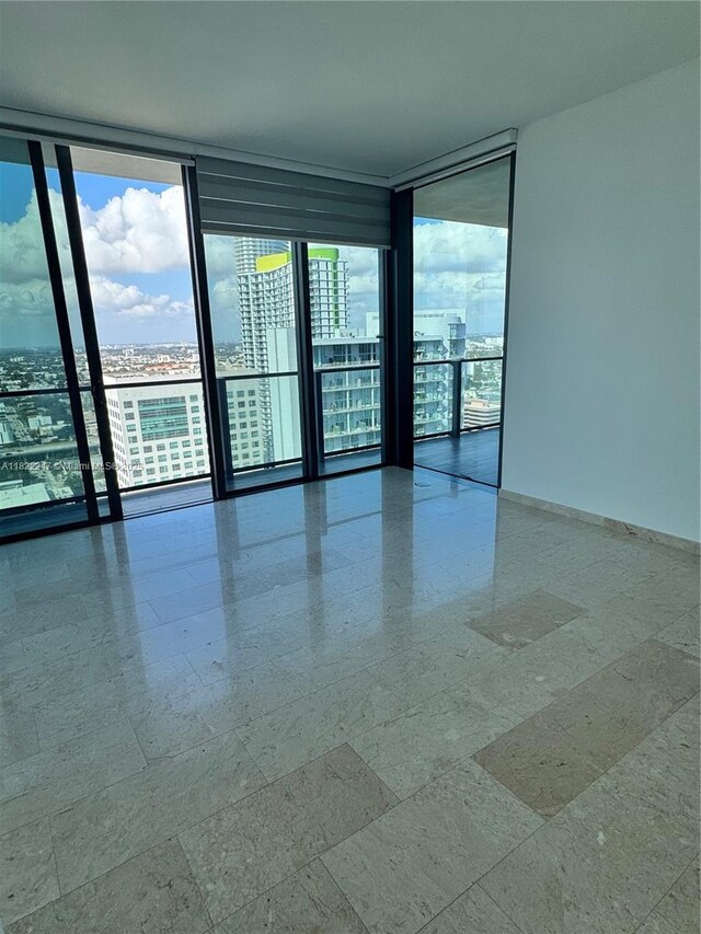 88 SW 7th St Unit 3012, Miami, FL 33130 - empty room featuring expansive windows, healthy amount of natural light, and a view of city