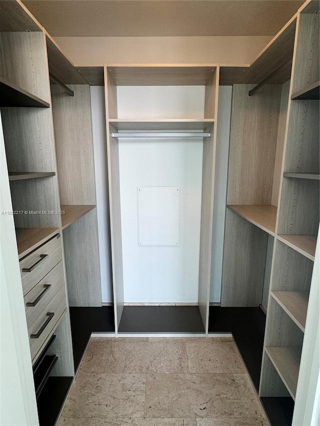 88 SW 7th St Unit 3012, Miami, FL 33130 - walk in closet featuring stone finish floors