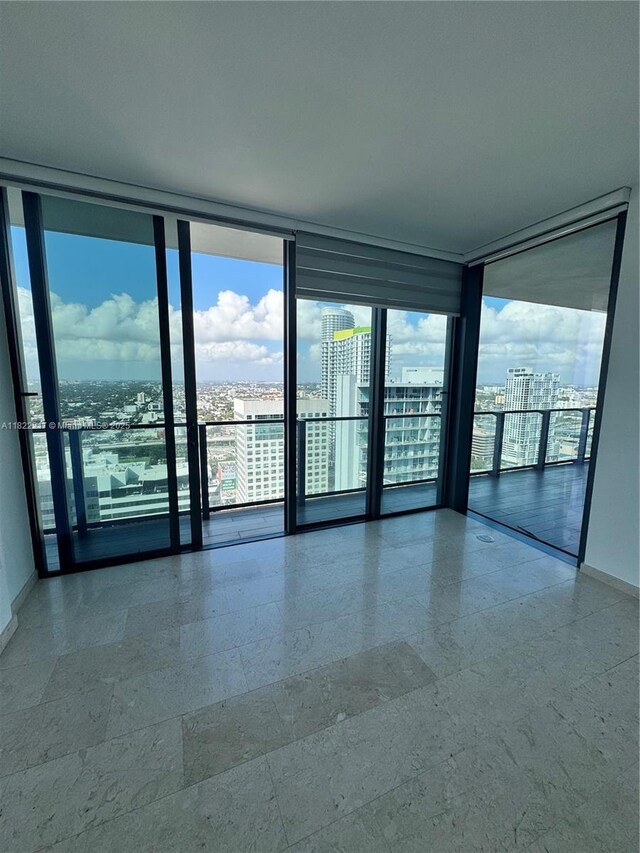 88 SW 7th St Unit 3012, Miami, FL 33130 - empty room featuring a wall of windows and a view of city
