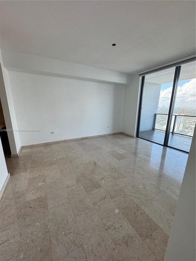 88 SW 7th St Unit 3012, Miami, FL 33130 - empty room with expansive windows and baseboards