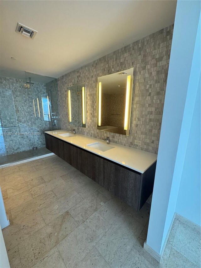 88 SW 7th St Unit 3012, Miami, FL 33130 - bathroom featuring a tile shower, double vanity, and tile walls