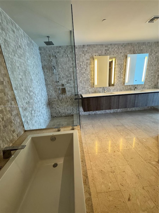 88 SW 7th St Unit 3012, Miami, FL 33130 - full bathroom featuring walk in shower, double vanity, a garden tub, and tile walls