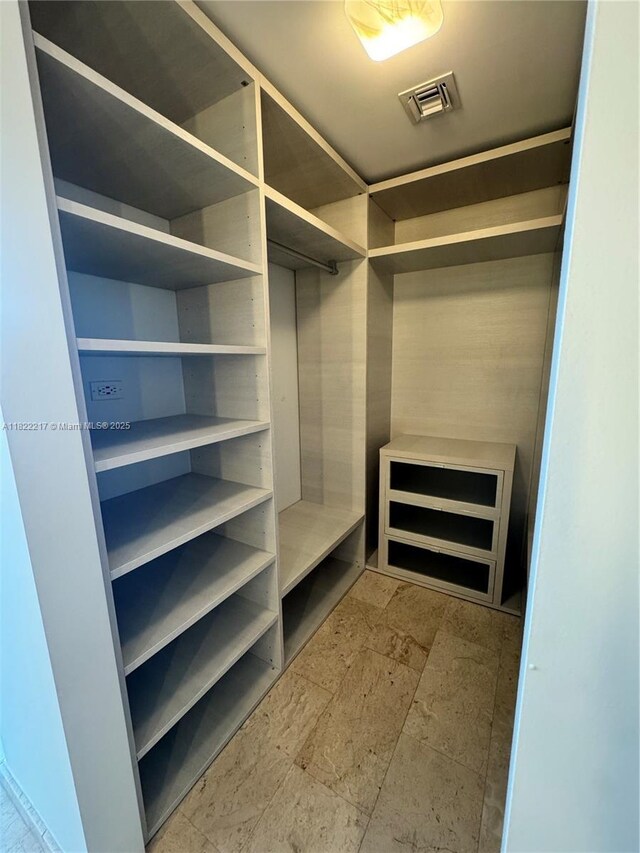 88 SW 7th St Unit 3012, Miami, FL 33130 - spacious closet featuring stone tile floors