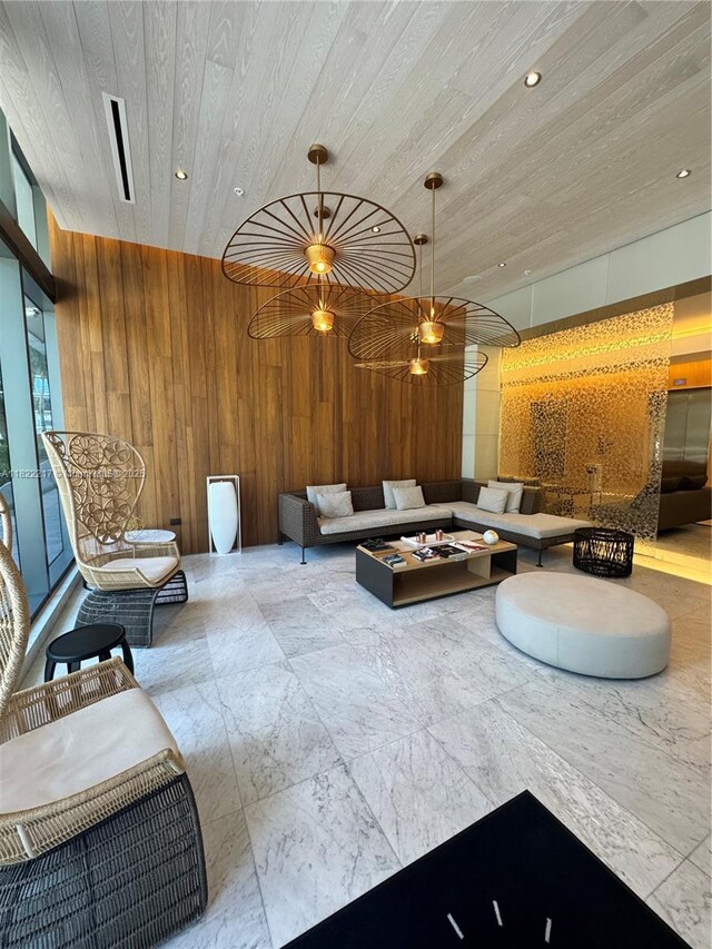 88 SW 7th St Unit 3012, Miami, FL 33130 - living area featuring wooden walls, wood ceiling, marble look tile flooring, and recessed lighting