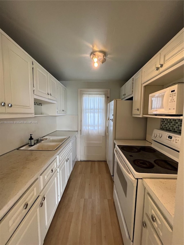 1475 NE 125th Ter Unit 511B, North Miami, FL 33161 - kitchen featuring white appliances, light wood-type flooring, white cabinets, and decorative backsplash